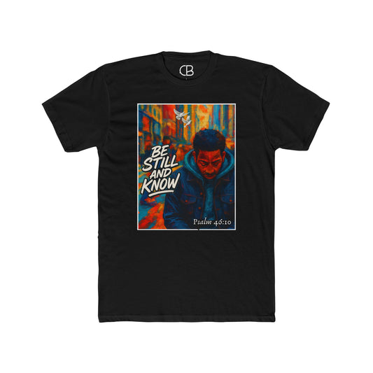 Solid black T-shirt featuring the Be Still And Know graphic with an urban portrait, a white dove, vibrant city artwork, and Psalm 46:10 scripture.
