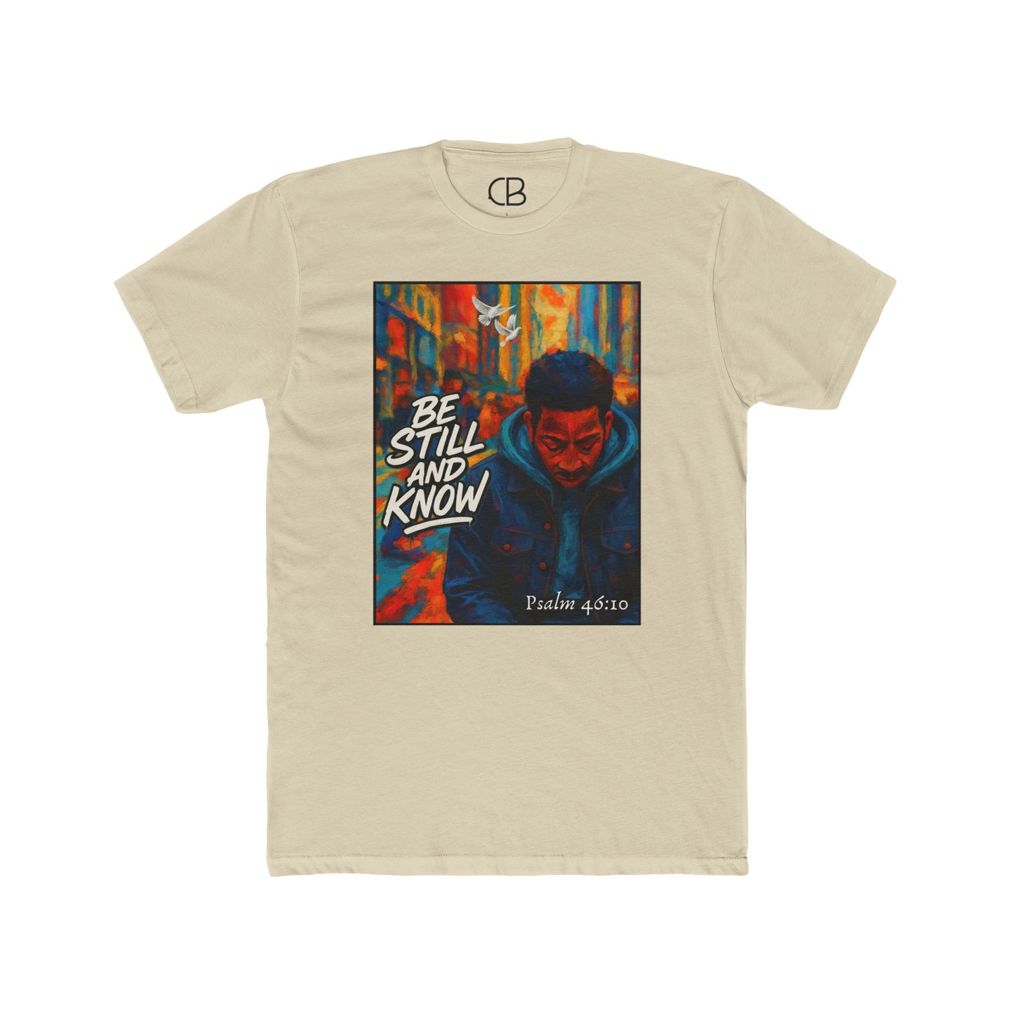 Solid Cream T-shirt featuring the Be Still And Know graphic with an urban portrait, a white dove, vibrant city artwork, and Psalm 46:10 scripture.