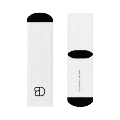 White crew socks with black accents on the toe, heel, and top, featuring the Culture Belly logo and sleek ribbed design, made from a soft polyester blend for comfort and durability.