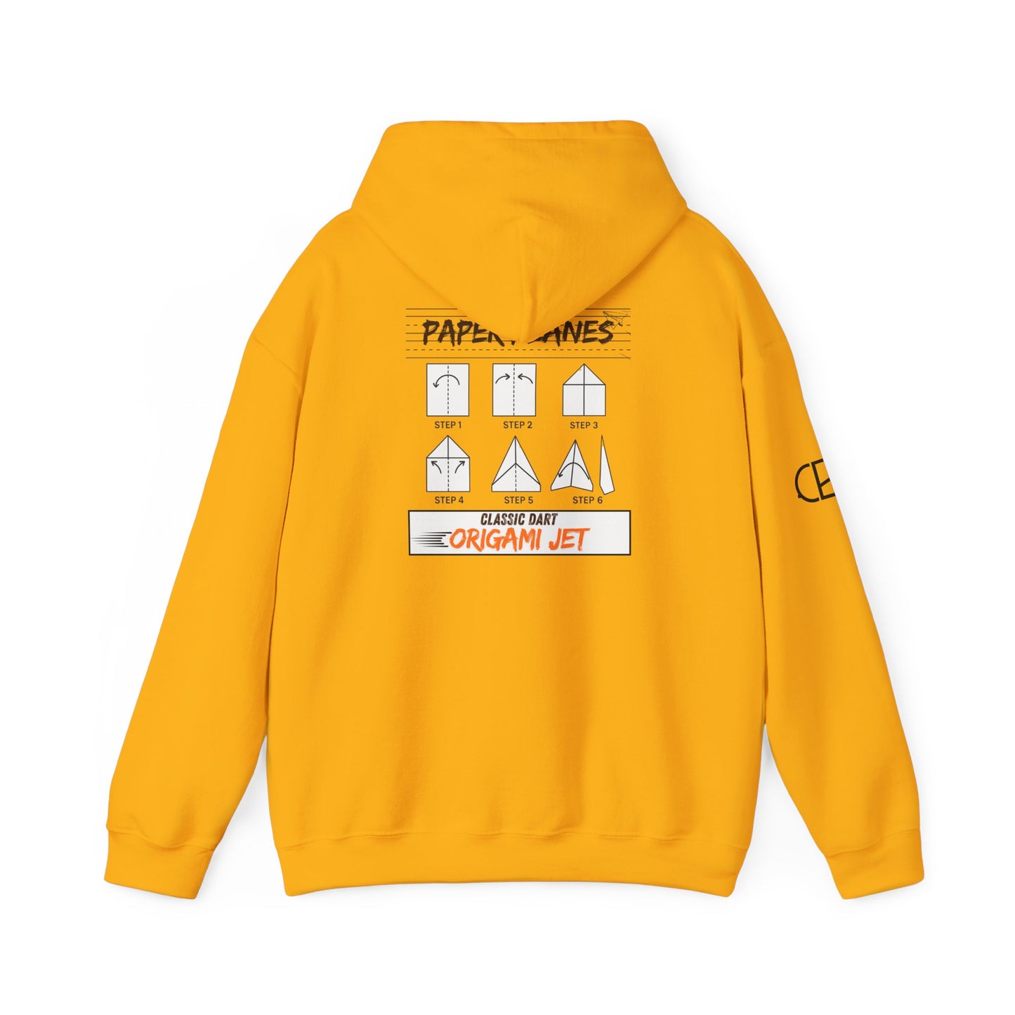 Gold pullover hoodie featuring the Paper Planes folding guide graphic with paper airplane instructions, New York City-inspired "Origami Jet" artwork, and a CB logo on the sleeve.