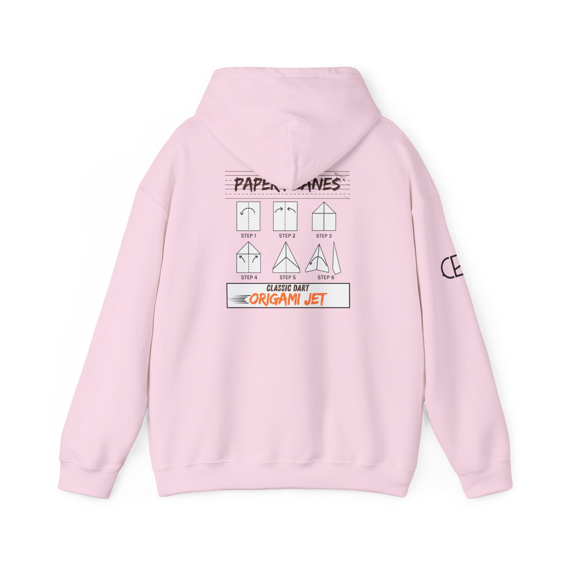Light Pink pullover hoodie featuring the Paper Planes folding guide graphic with paper airplane instructions, New York City-inspired "Origami Jet" artwork, and a CB logo on the sleeve.