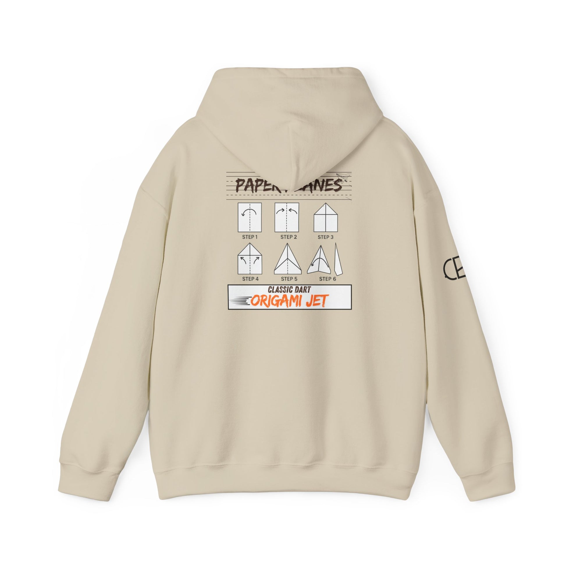 Sand pullover hoodie featuring the Paper Planes folding guide graphic with paper airplane instructions, New York City-inspired "Origami Jet" artwork, and a CB logo on the sleeve.