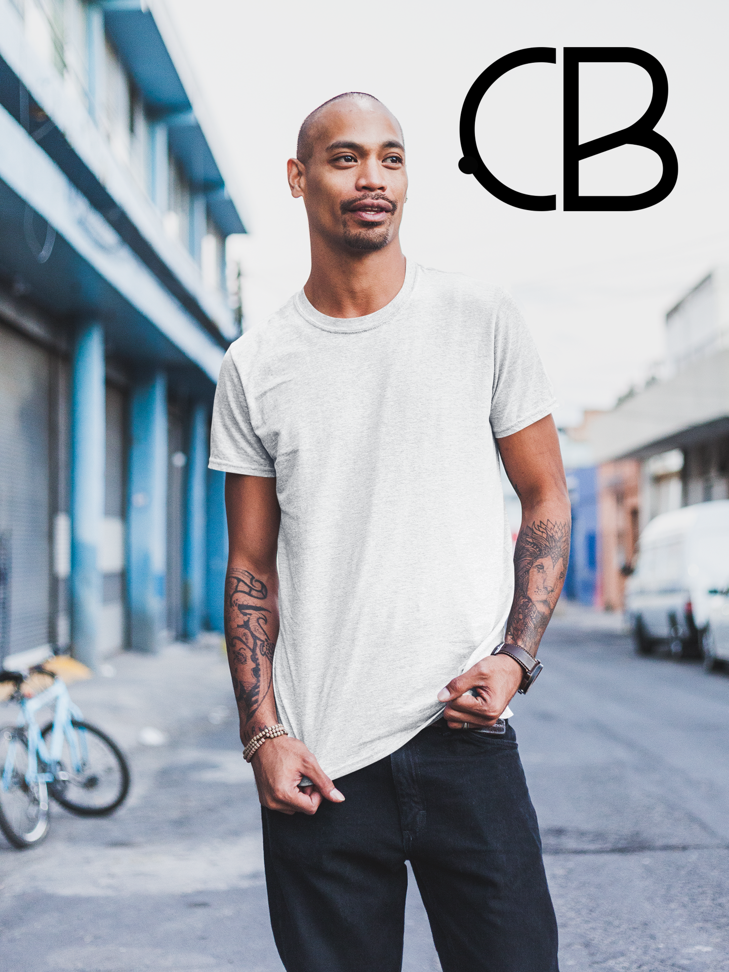 Model wearing a classic white crew neck t-shirt paired with black pants, standing confidently on a city street, with the Culture Belly logo displayed in the corner.